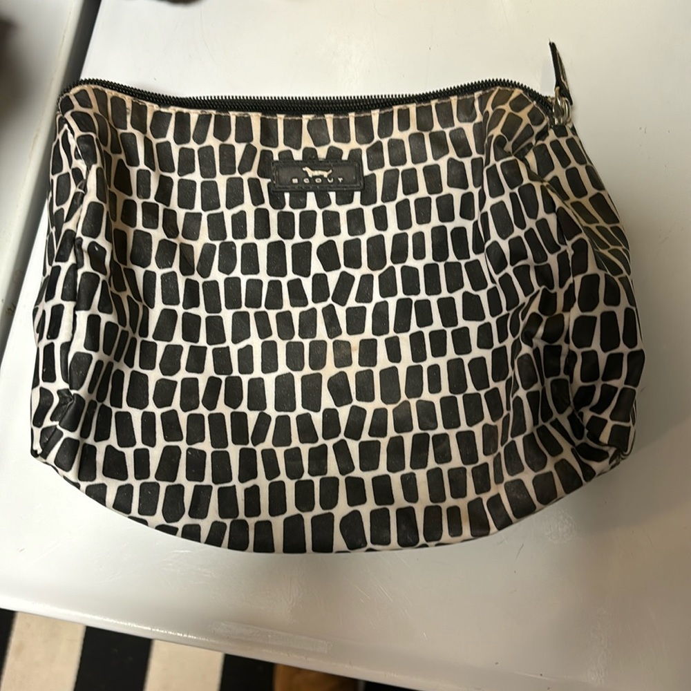 Scout packing heat makeup bag.